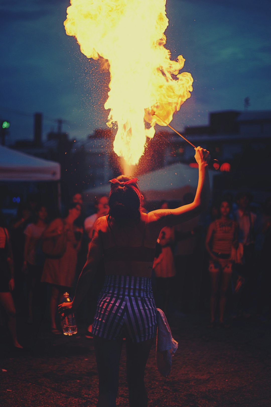 woman-performing-fire-spitting-e-i18ox5nq